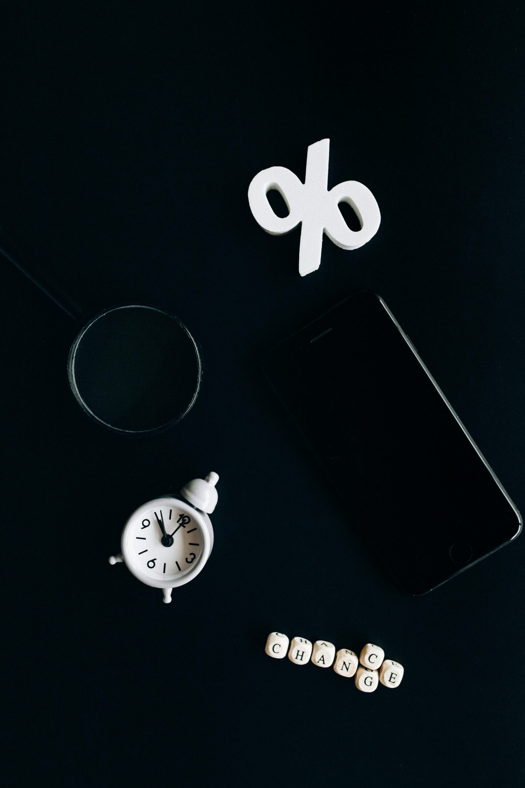 IT Services Stylish composition of clock, symbols, and text representing financial change on a dark background.