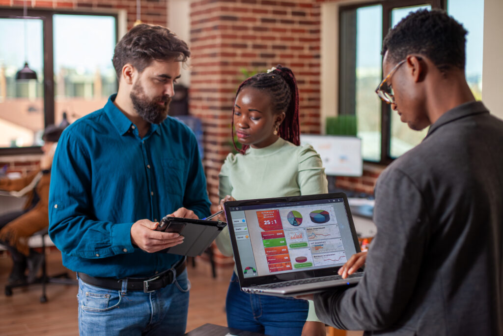 coworkers use digital devices in office